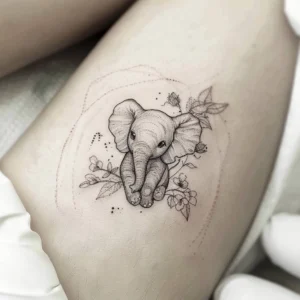 cute baby elephant tattoo design with flowers and dot work in black and grey
